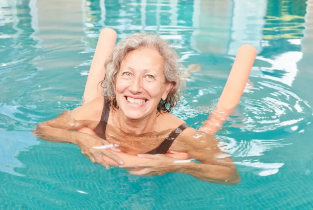 Adult woman with a pool nooldle