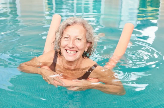 Adult woman with a pool nooldle