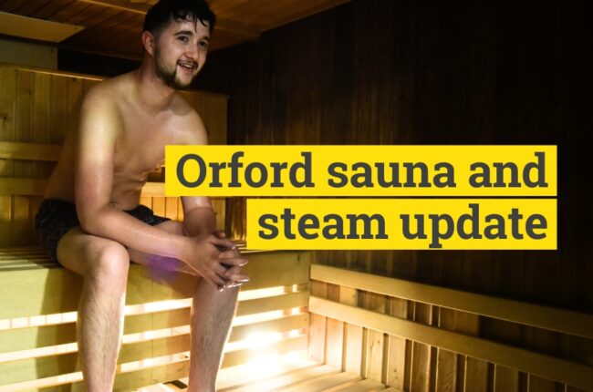 young man sat in sauna and steam